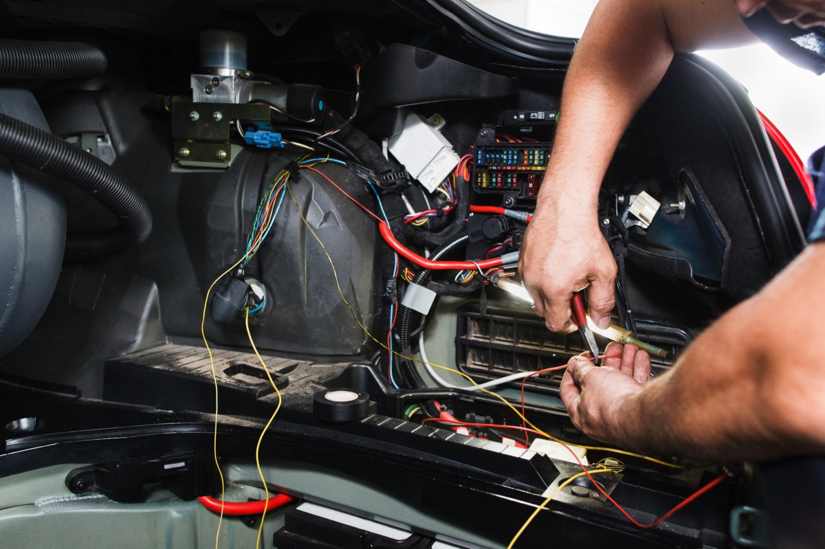 mechanic working on auto electrical system